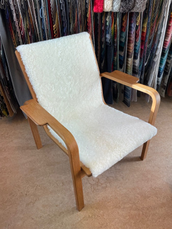 Fåtölj av Yngve Ekström omklädd i fårskinn Offwhite.